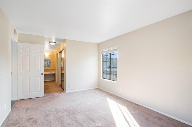 empty room featuring light carpet