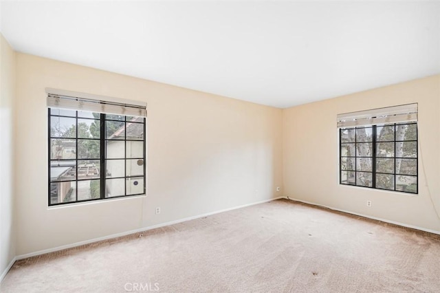 unfurnished room with light carpet