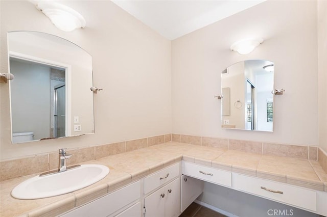 bathroom with toilet and vanity