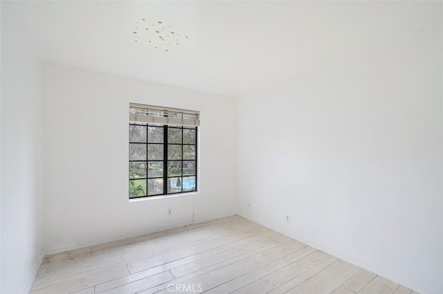 unfurnished room featuring light hardwood / wood-style floors