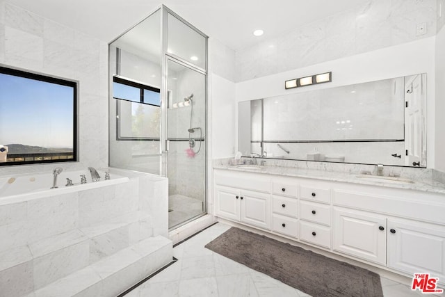 bathroom featuring shower with separate bathtub and vanity