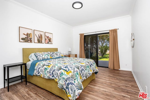 bedroom with hardwood / wood-style flooring, crown molding, and access to outside