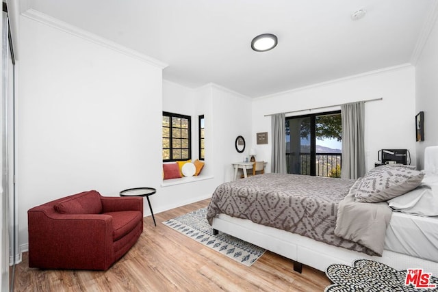 bedroom with hardwood / wood-style floors and ornamental molding