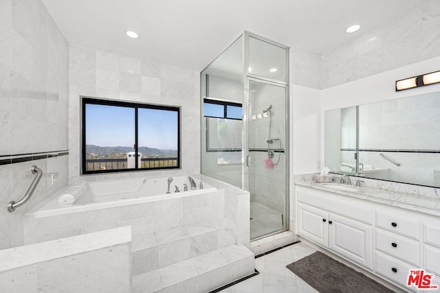 bathroom featuring vanity and separate shower and tub