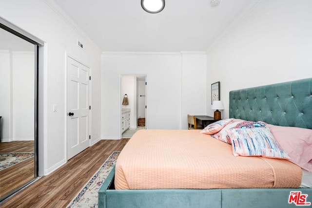 bedroom with ornamental molding and wood-type flooring