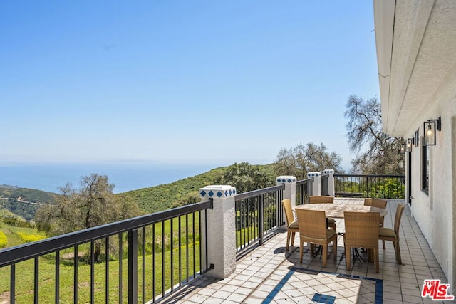 balcony featuring a water view