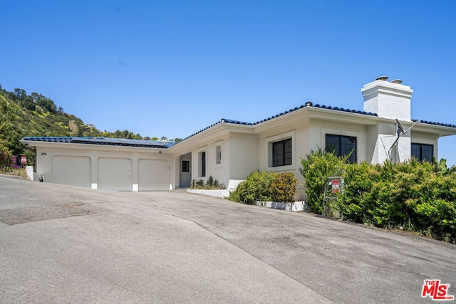 mediterranean / spanish-style home featuring a garage