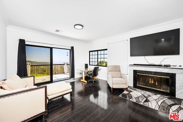 living room with a high end fireplace and crown molding