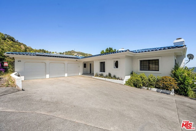 mediterranean / spanish house featuring a garage