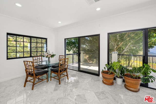 dining space featuring crown molding