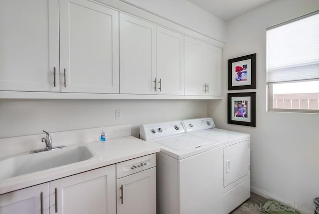 clothes washing area featuring cabinets, independent washer and dryer, and sink