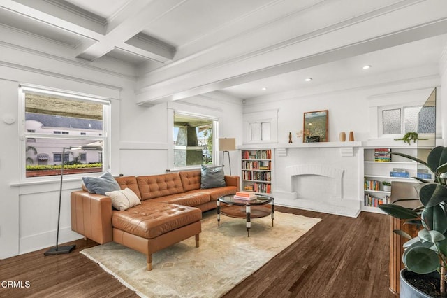 sitting room with beam ceiling, a fireplace, coffered ceiling, and dark hardwood / wood-style floors