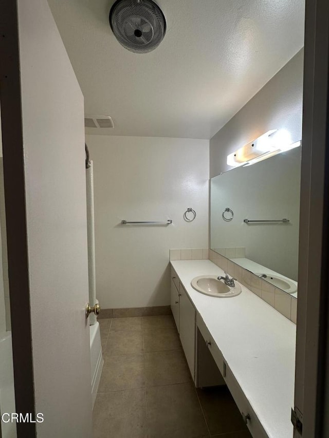 bathroom with tile patterned flooring and vanity