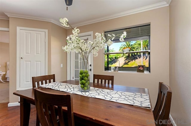 dining area featuring crown molding and hardwood / wood-style flooring