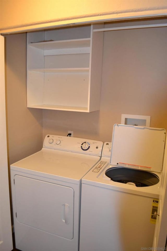 clothes washing area featuring independent washer and dryer