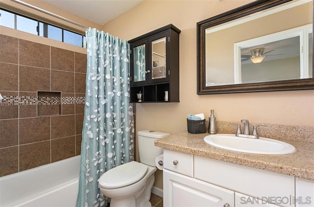 full bathroom featuring toilet, vanity, ceiling fan, and shower / bath combination with curtain