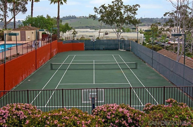 view of sport court with a mountain view and basketball court