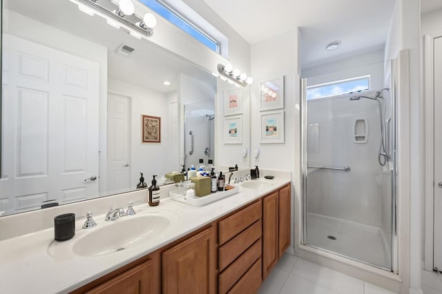 bathroom featuring an enclosed shower, vanity, and tile patterned floors