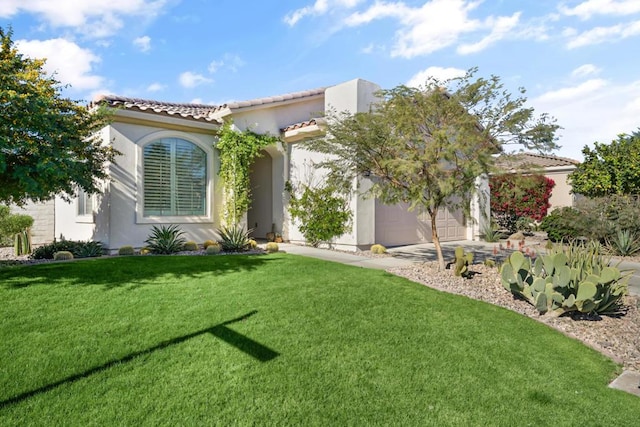 mediterranean / spanish-style house featuring a garage and a front lawn