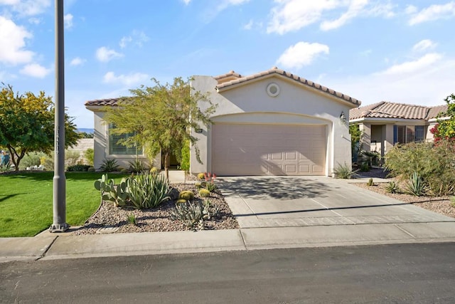 mediterranean / spanish-style house with a garage and a front yard