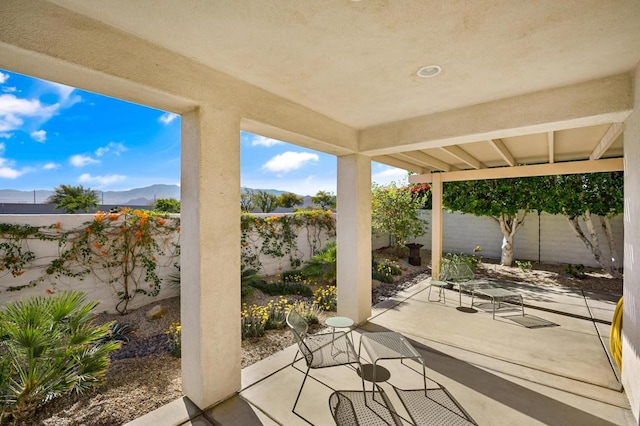 view of patio / terrace with a mountain view