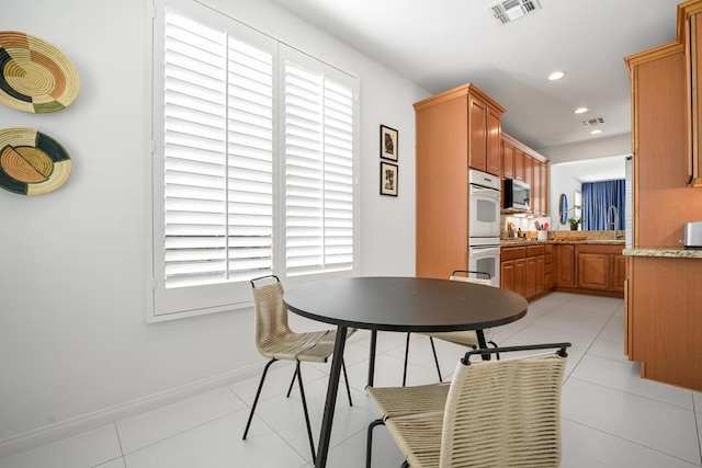 dining room featuring light tile patterned flooring