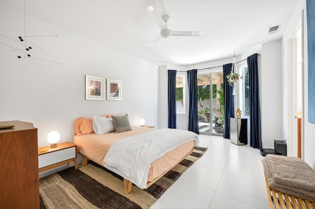 tiled bedroom with ceiling fan and access to exterior