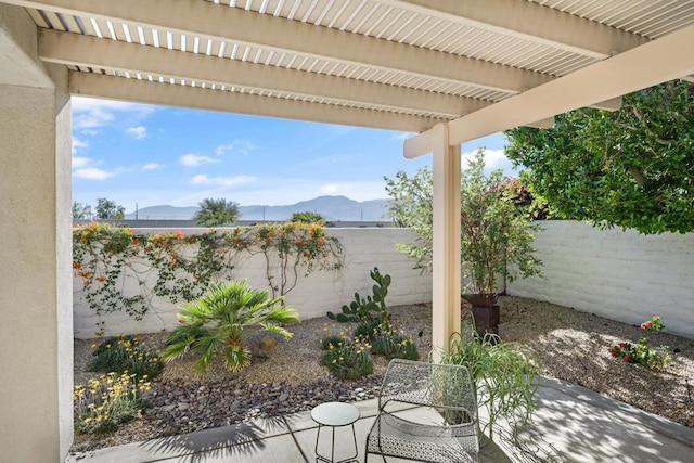 view of patio with a mountain view and a pergola