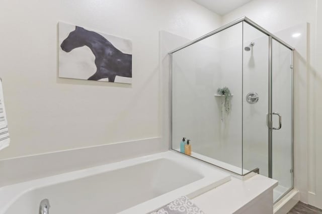 bathroom with separate shower and tub