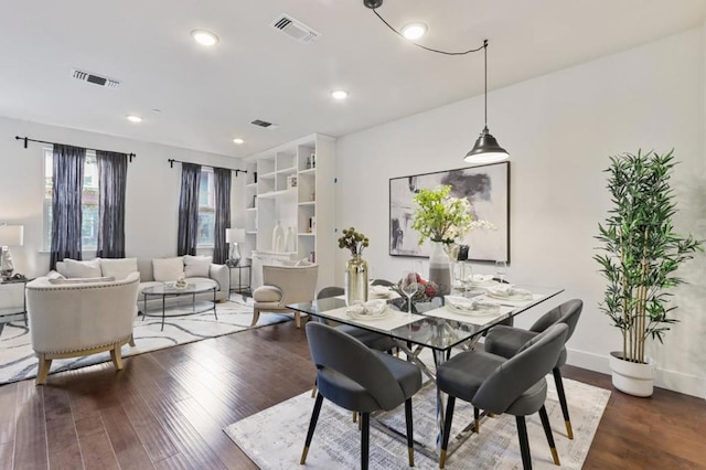 dining space with hardwood / wood-style floors