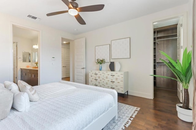 bedroom with ceiling fan, ensuite bathroom, dark hardwood / wood-style floors, and a closet