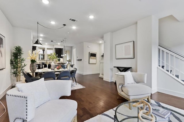 living room with dark hardwood / wood-style flooring