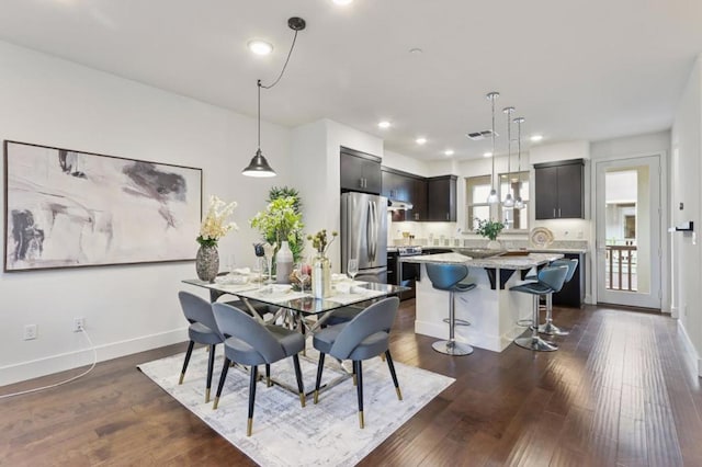 dining space featuring dark hardwood / wood-style floors