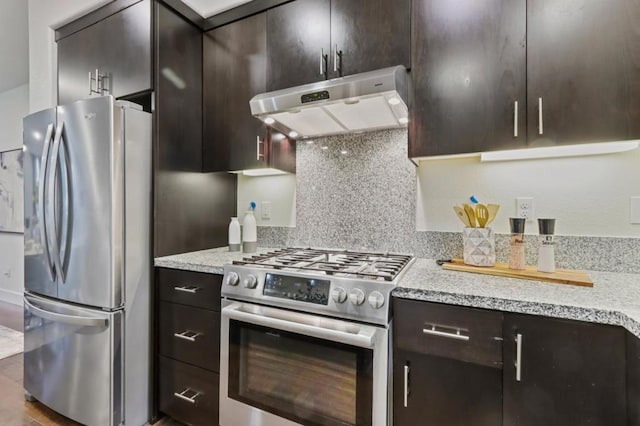 kitchen featuring appliances with stainless steel finishes, dark brown cabinets, hardwood / wood-style flooring, and tasteful backsplash