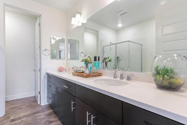 bathroom with walk in shower and vanity