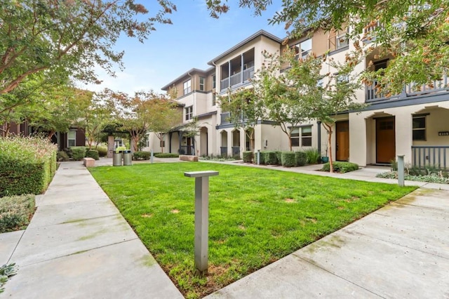 view of home's community featuring a lawn