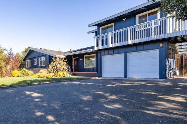 view of property featuring a garage and a balcony