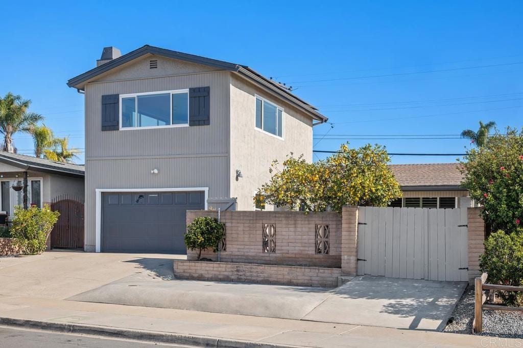 view of front of home featuring a gate, driveway, a chimney, and fence