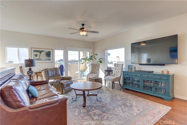 living room featuring ceiling fan and hardwood / wood-style floors