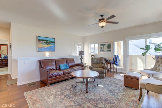 living room featuring ceiling fan and hardwood / wood-style floors