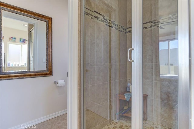 bathroom featuring a shower with shower door