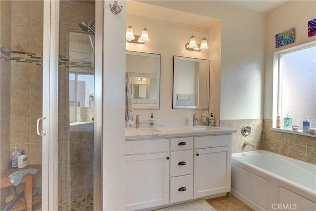 bathroom featuring tile patterned flooring, vanity, and plus walk in shower