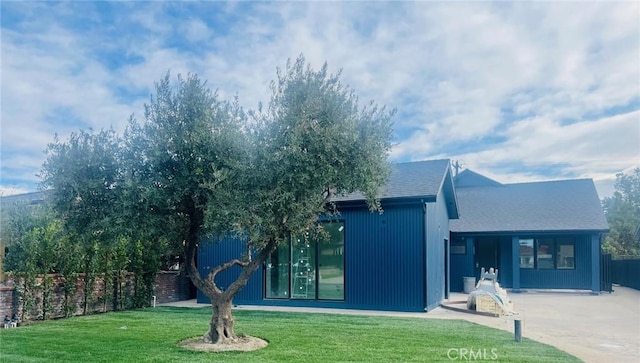 rear view of house with a lawn