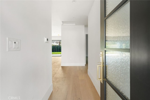 hallway featuring recessed lighting, baseboards, and wood finished floors