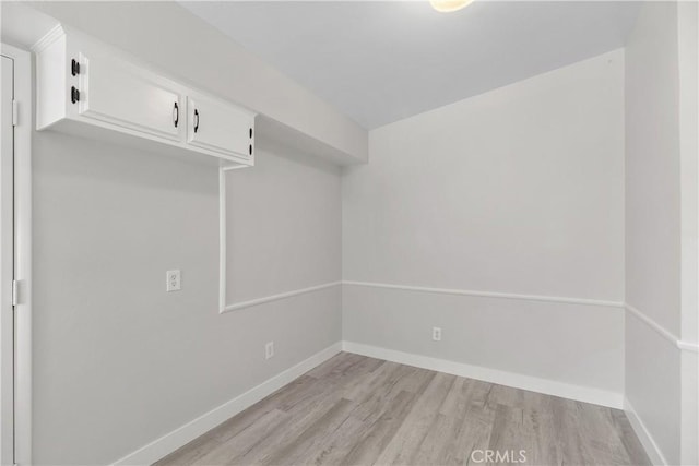 interior space with baseboards and light wood-style floors