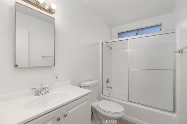 bathroom with toilet, combined bath / shower with glass door, and vanity