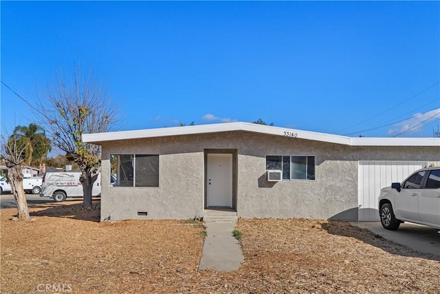 view of front of house with crawl space and stucco siding