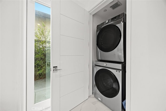 washroom featuring stacked washer and dryer