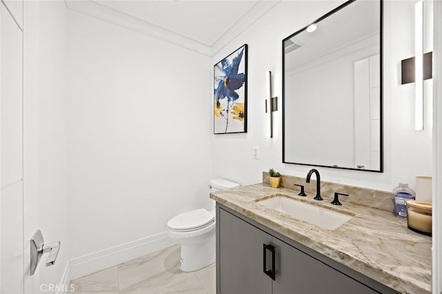 bathroom featuring toilet, ornamental molding, and vanity