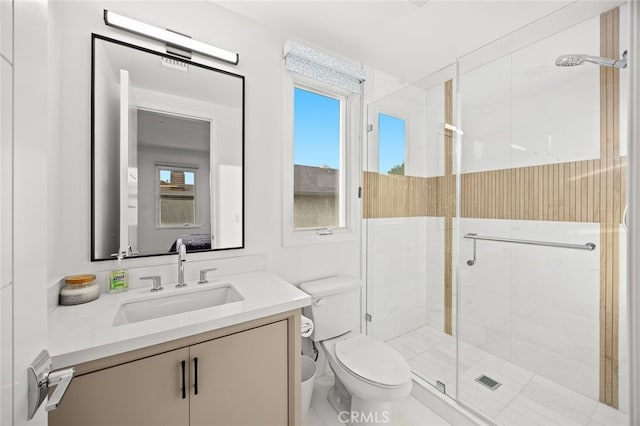 bathroom with a shower with door, toilet, and vanity